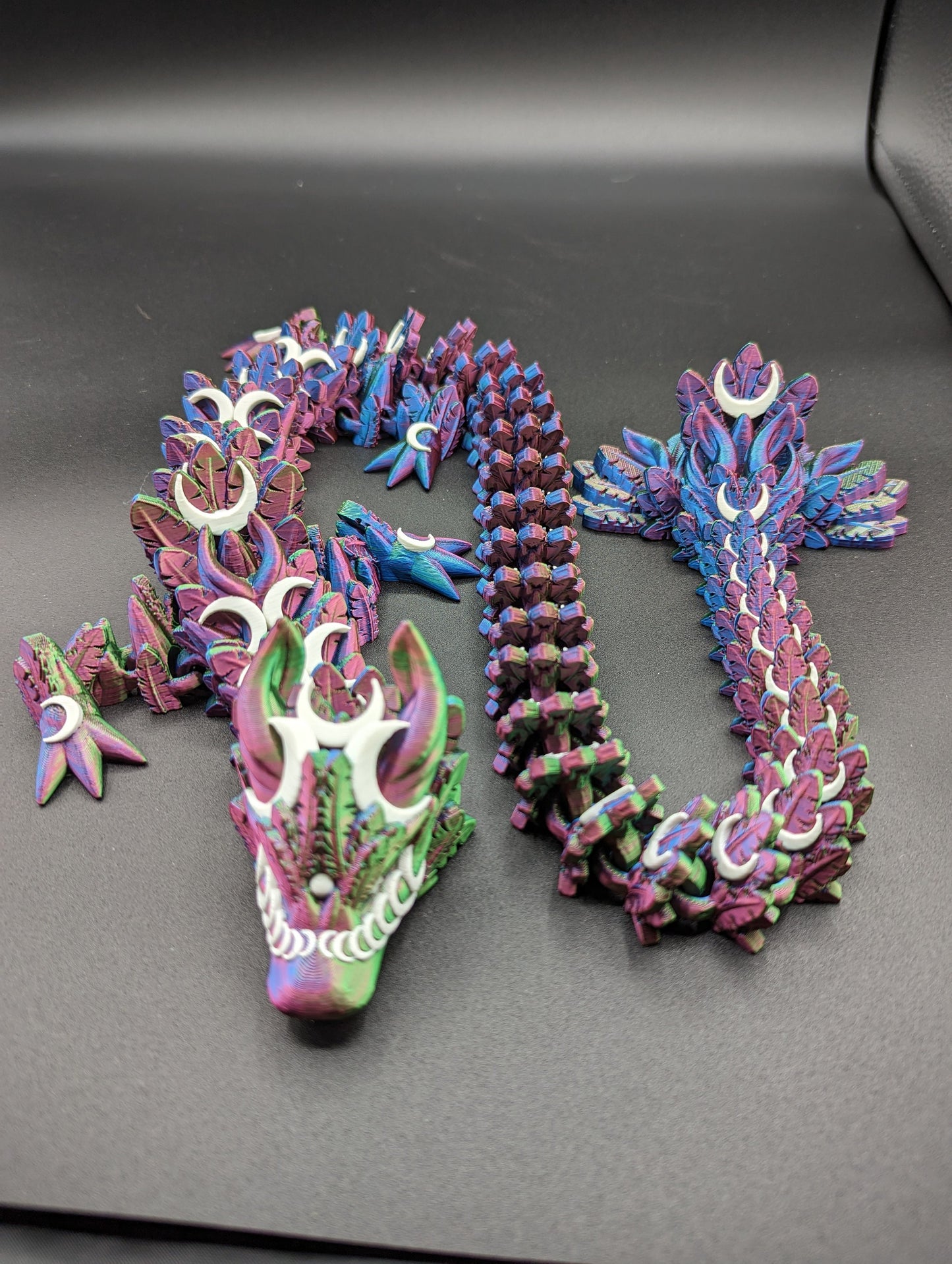 Introducing our Mystical Lunar Dragon, a captivating piece perfect for fantasy lovers and collectors alike. This ethereal dragon is designed to add a touch of magic and wonder to any space.