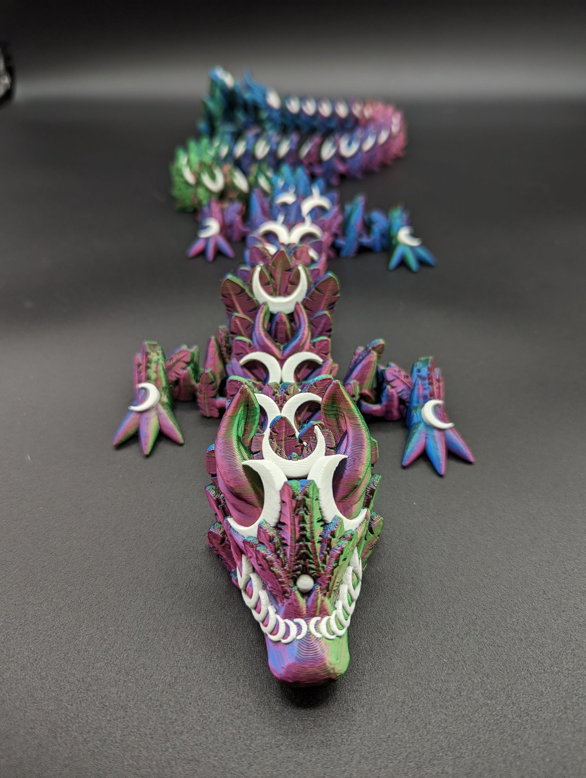 Introducing our Mystical Lunar Dragon, a captivating piece perfect for fantasy lovers and collectors alike. This ethereal dragon is designed to add a touch of magic and wonder to any space.