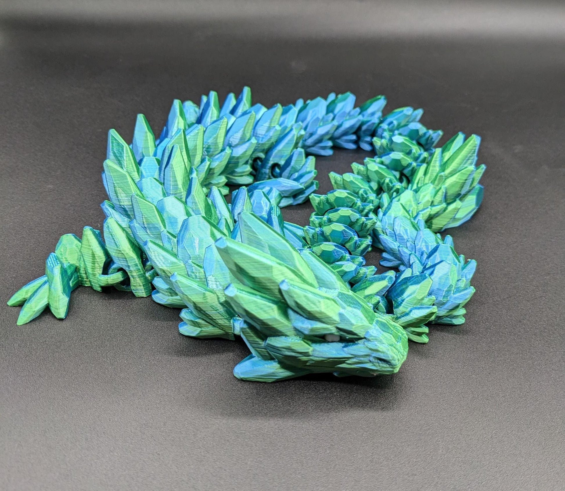 Our Beautiful Large Articulating Gemstone Dragon, combines the mystique of dragons with the elegance of gemstones is perfect for collectors, fantasy enthusiasts, and anyone looking to add a touch of magic to their home or office.