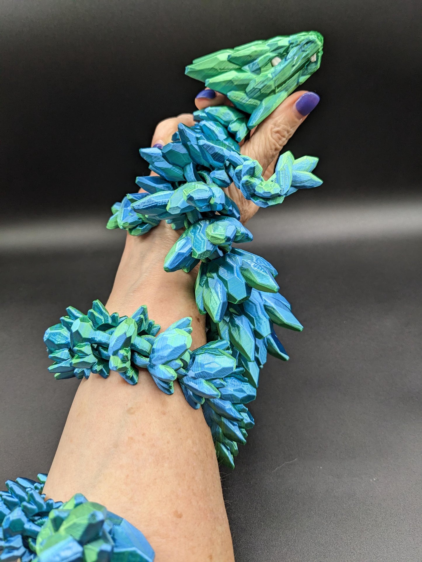 Our Beautiful Large Articulating Gemstone Dragon, combines the mystique of dragons with the elegance of gemstones is perfect for collectors, fantasy enthusiasts, and anyone looking to add a touch of magic to their home or office.