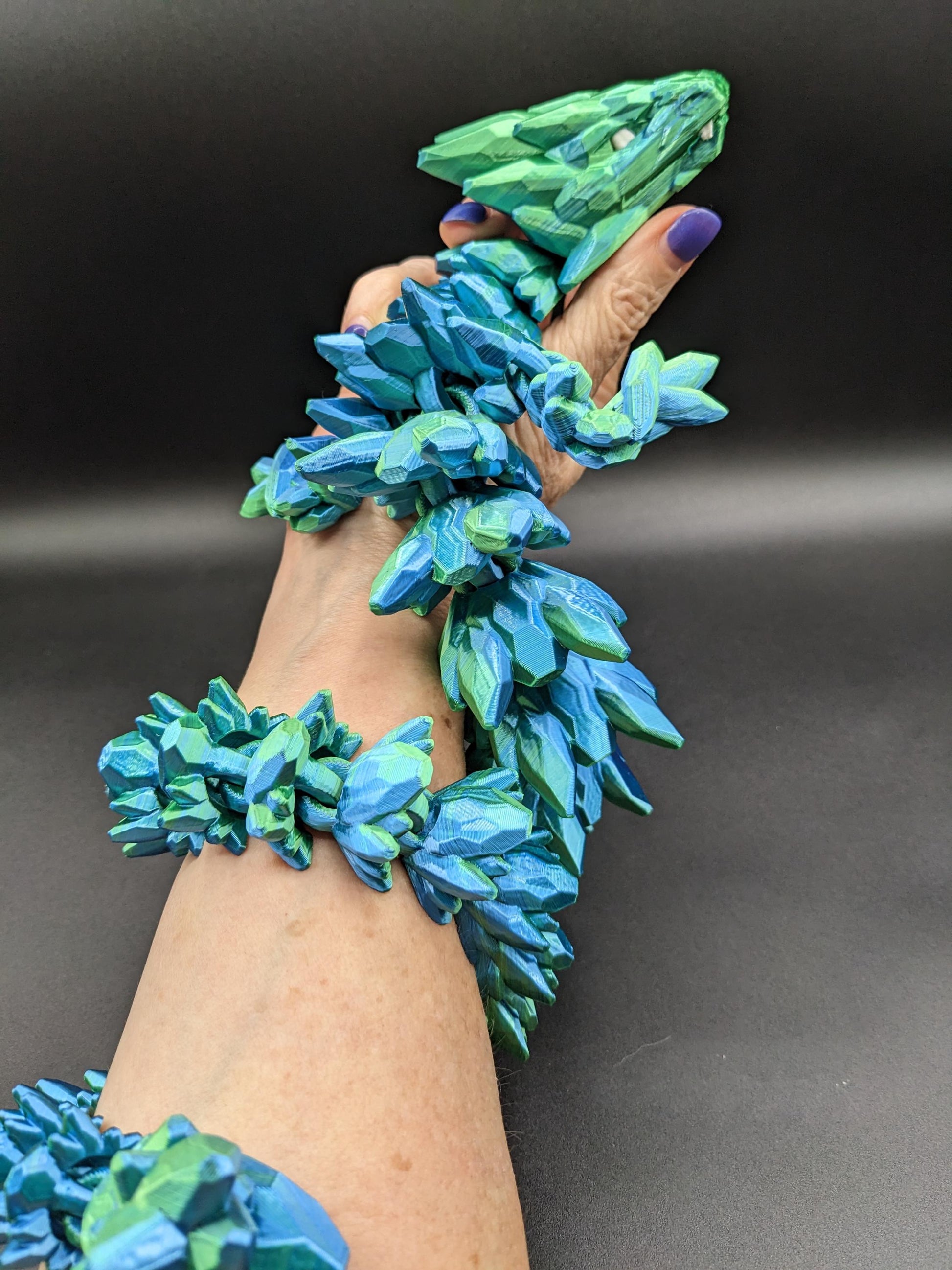 Our Beautiful Large Articulating Gemstone Dragon, combines the mystique of dragons with the elegance of gemstones is perfect for collectors, fantasy enthusiasts, and anyone looking to add a touch of magic to their home or office.