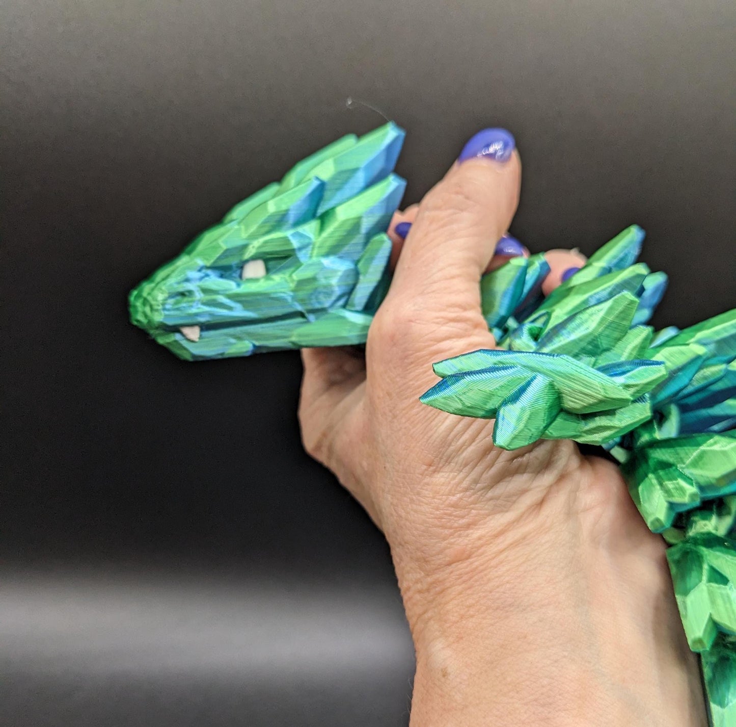 Our Beautiful Large Articulating Gemstone Dragon, combines the mystique of dragons with the elegance of gemstones is perfect for collectors, fantasy enthusiasts, and anyone looking to add a touch of magic to their home or office.
