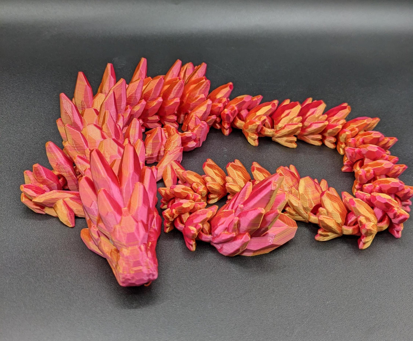 Our Beautiful Large Articulating Gemstone Dragon, combines the mystique of dragons with the elegance of gemstones is perfect for collectors, fantasy enthusiasts, and anyone looking to add a touch of magic to their home or office.