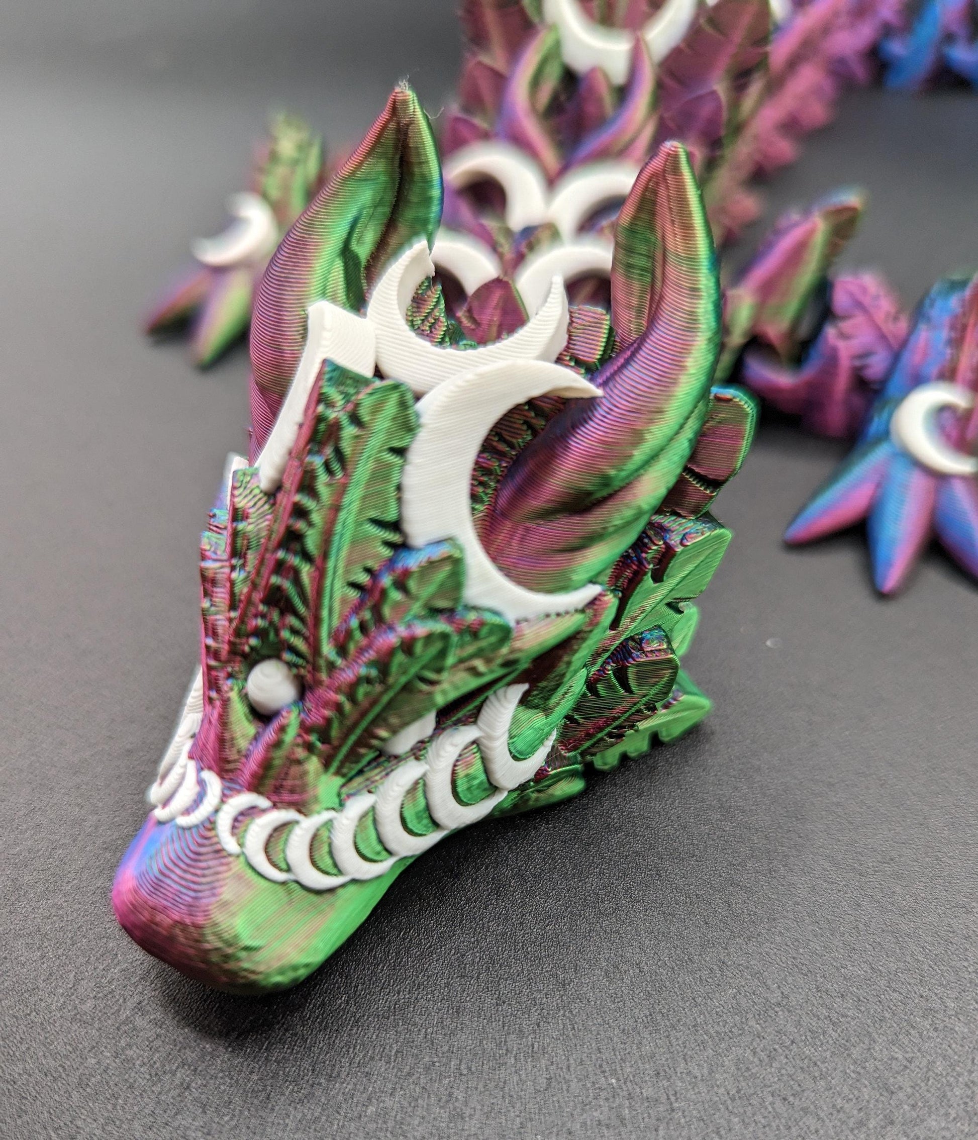 Introducing our Mystical Lunar Dragon, a captivating piece perfect for fantasy lovers and collectors alike. This ethereal dragon is designed to add a touch of magic and wonder to any space.