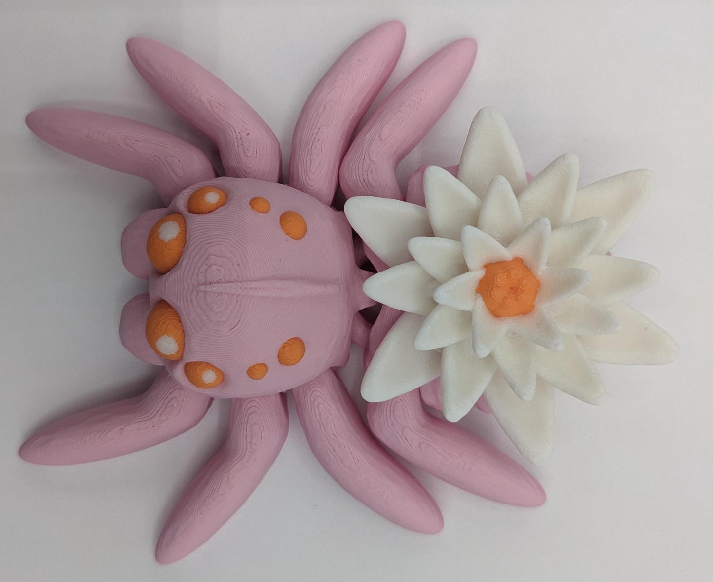 Introducing our Beautiful Articulating Water Lily Spider, a stunning blend of nature and art. Perfect for collectors and decor enthusiasts, this unique spider adds a touch of grace and whimsy to any space.