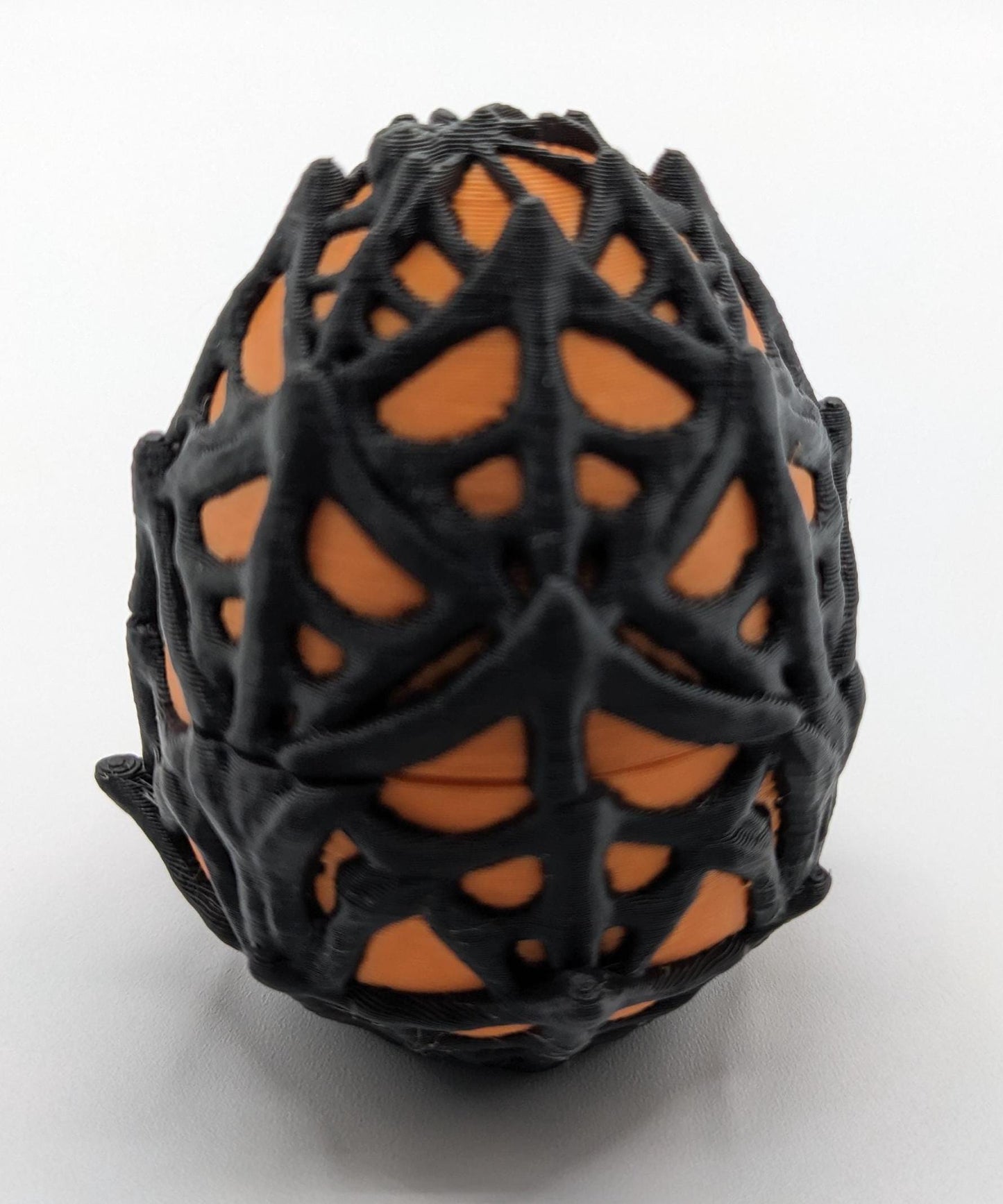 Our Spiderweb Egg with choice of spider captures the spooky fun of the season, a must-have for your festive collection. Perfect for adding a touch of mystery & fun to any room, this spiderweb egg combines intricate design with playful charm.
