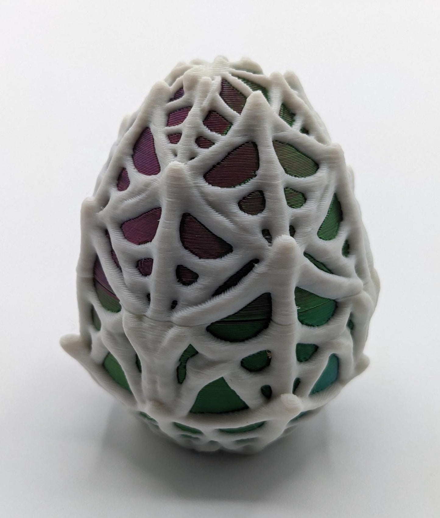 Our Spiderweb Egg with choice of spider captures the spooky fun of the season, a must-have for your festive collection. Perfect for adding a touch of mystery & fun to any room, this spiderweb egg combines intricate design with playful charm.