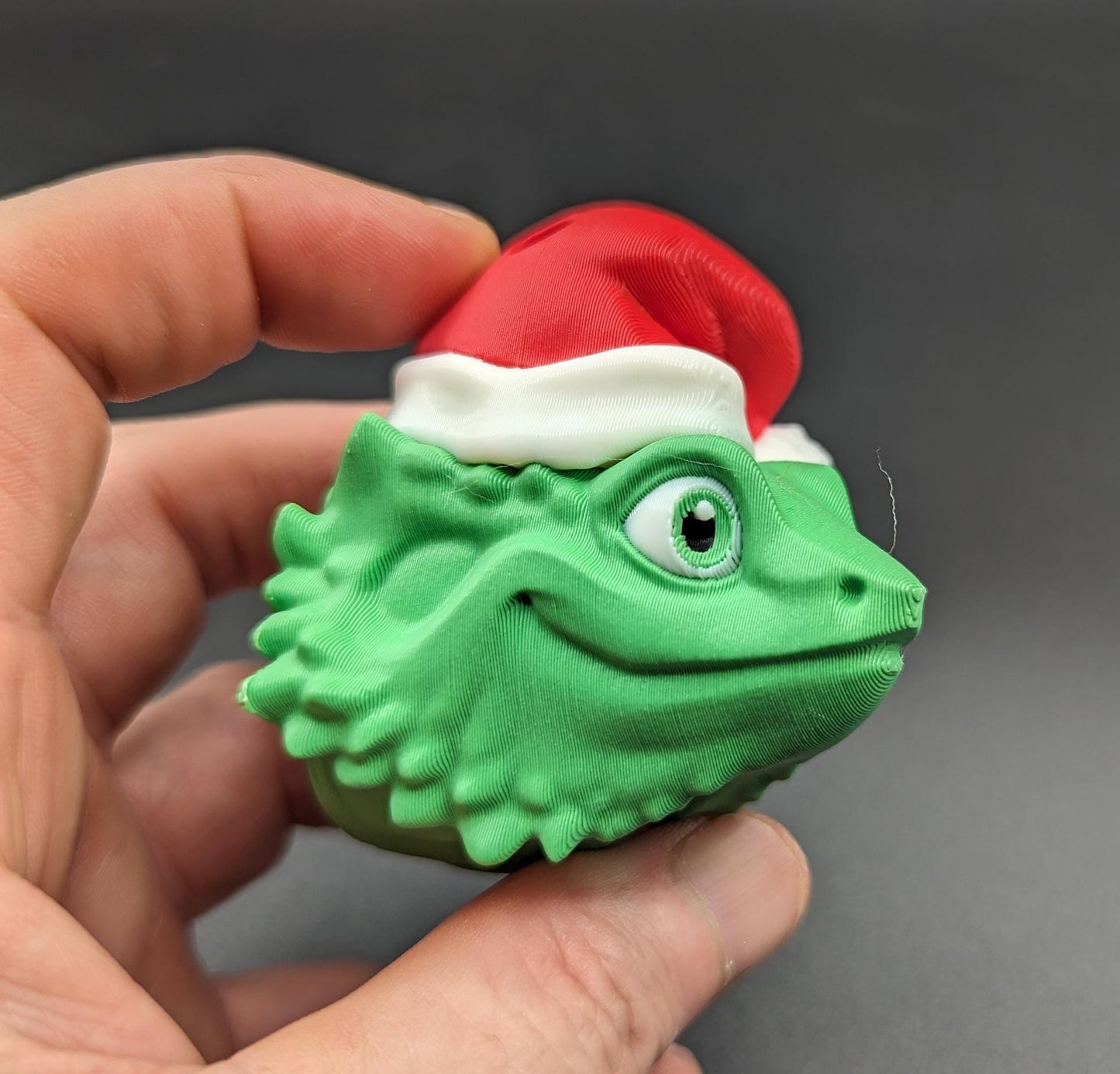 This charming ornament brings a touch of reptilian charm to your Christmas tree, making it a delightful and unique way to celebrate the season.