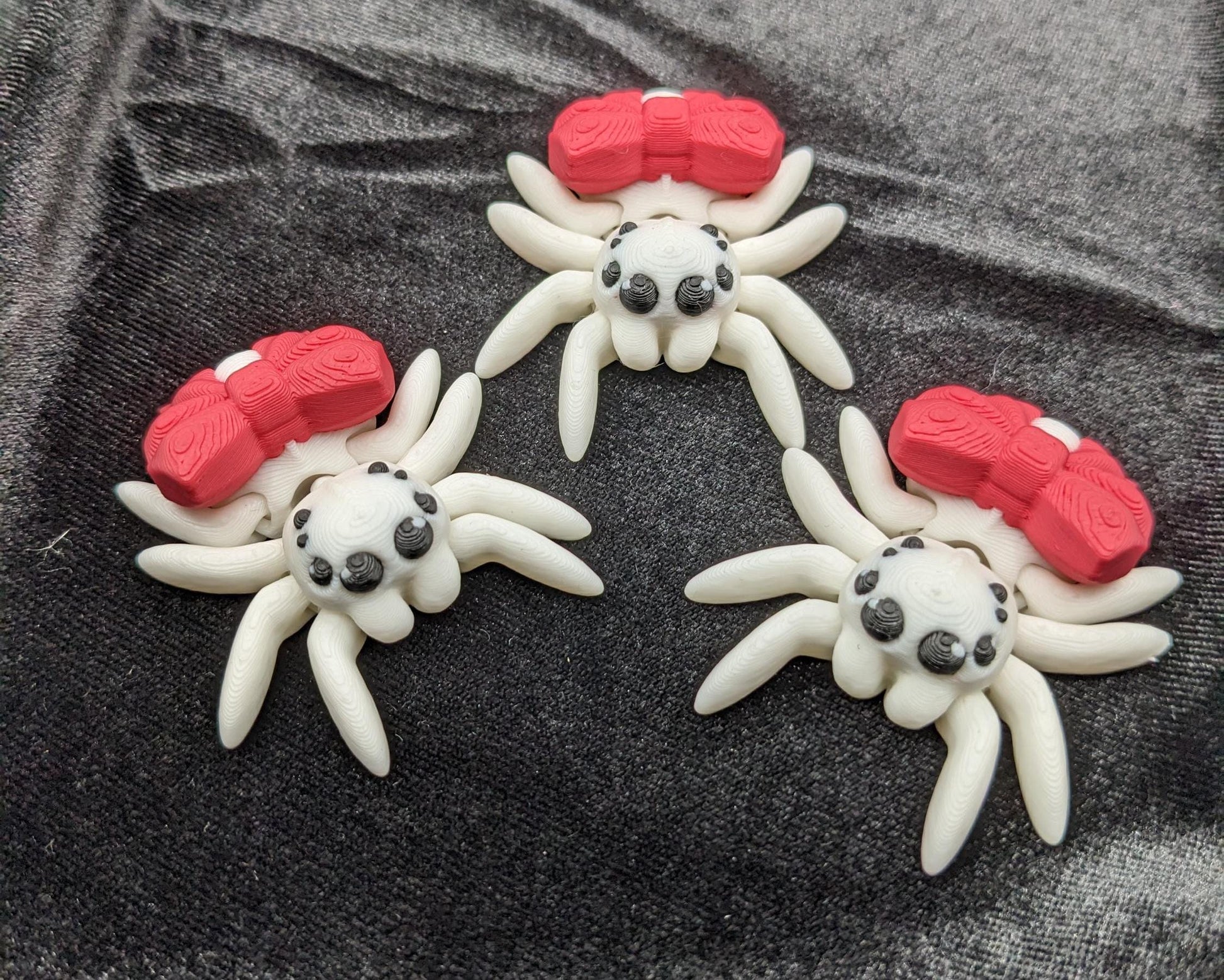 Our Beautiful Articulated Bow Spider Fidget Toy is  designed for both relaxation & decoration, is a versatile & delightful accessory. Its fully articulated body allows for posing, the bow adds a touch of charm that makes it perfect for the holidays.