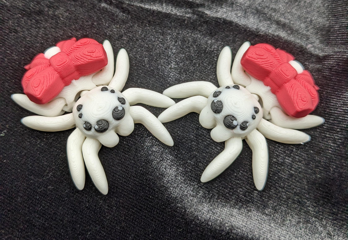 Our Beautiful Articulated Bow Spider Fidget Toy is  designed for both relaxation & decoration, is a versatile & delightful accessory. Its fully articulated body allows for posing, the bow adds a touch of charm that makes it perfect for the holidays.