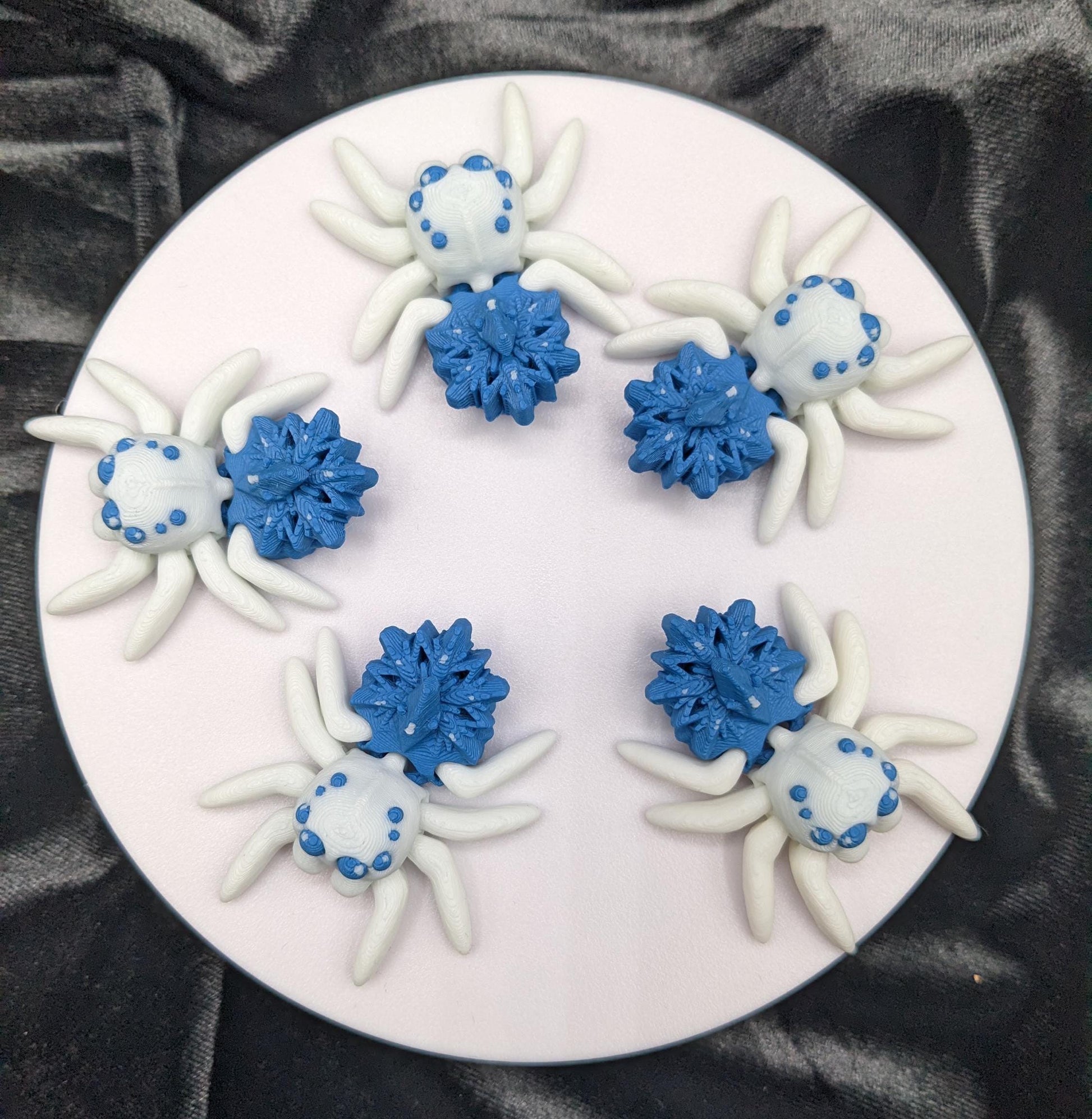 Capture the beauty of winter with our Articulated Snowflake Spider Fidget Toy! This one-of-a-kind spider features intricate snowflake design on its body adding a festive and elegant touch to its playful functionality.