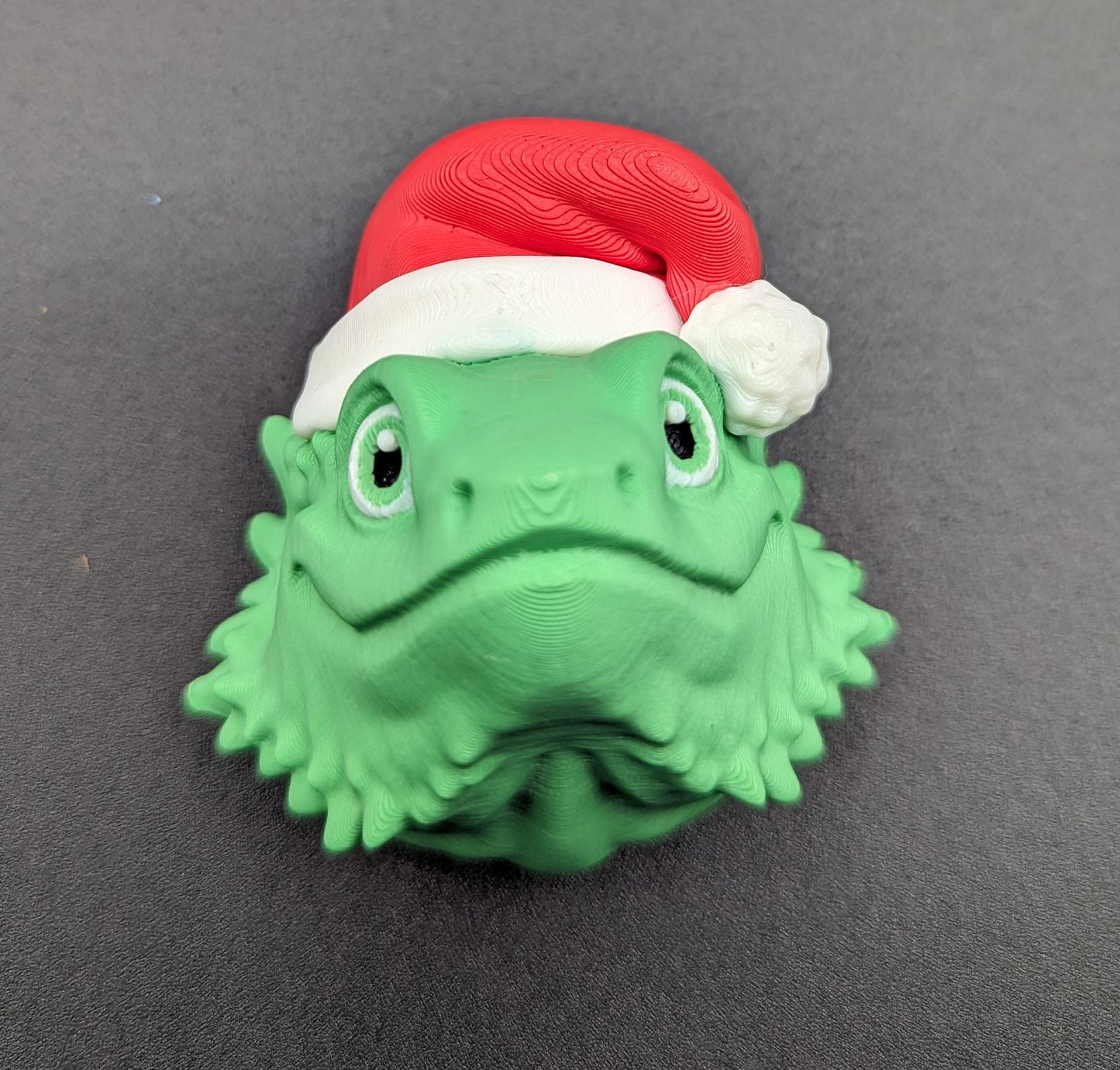 This charming ornament brings a touch of reptilian charm to your Christmas tree, making it a delightful and unique way to celebrate the season.
