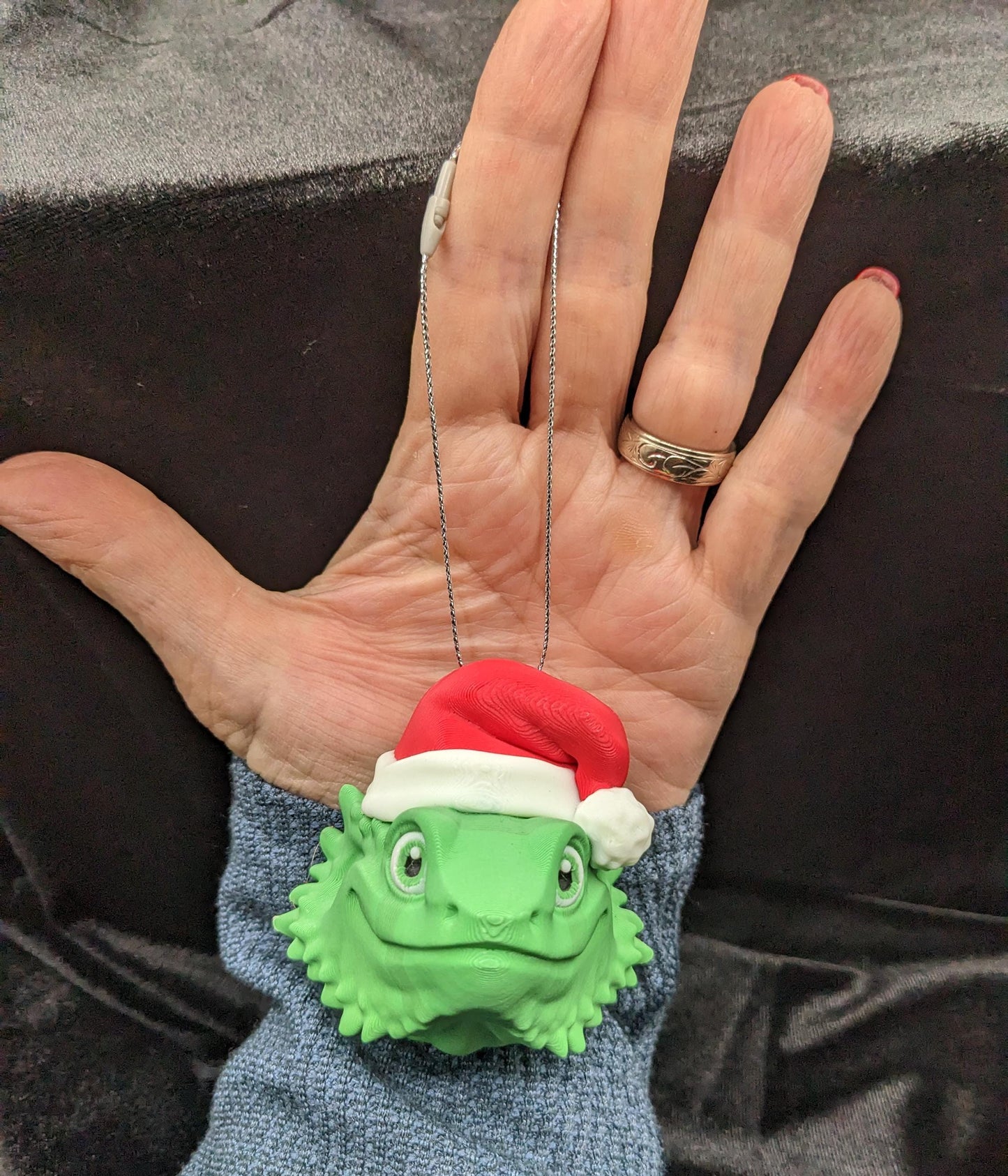 This charming ornament brings a touch of reptilian charm to your Christmas tree, making it a delightful and unique way to celebrate the season.