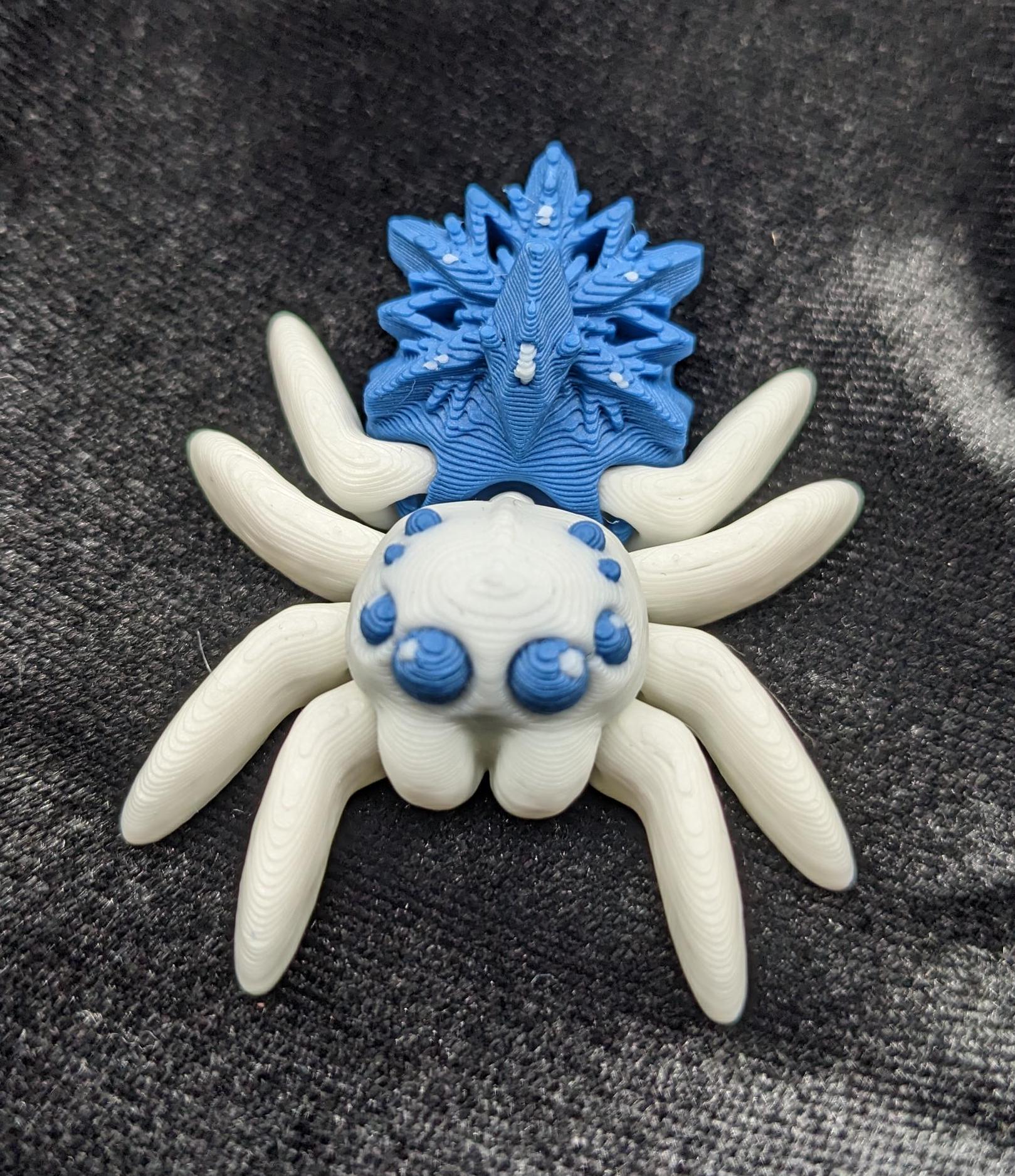 Capture the beauty of winter with our Articulated Snowflake Spider Fidget Toy! This one-of-a-kind spider features intricate snowflake design on its body adding a festive and elegant touch to its playful functionality.