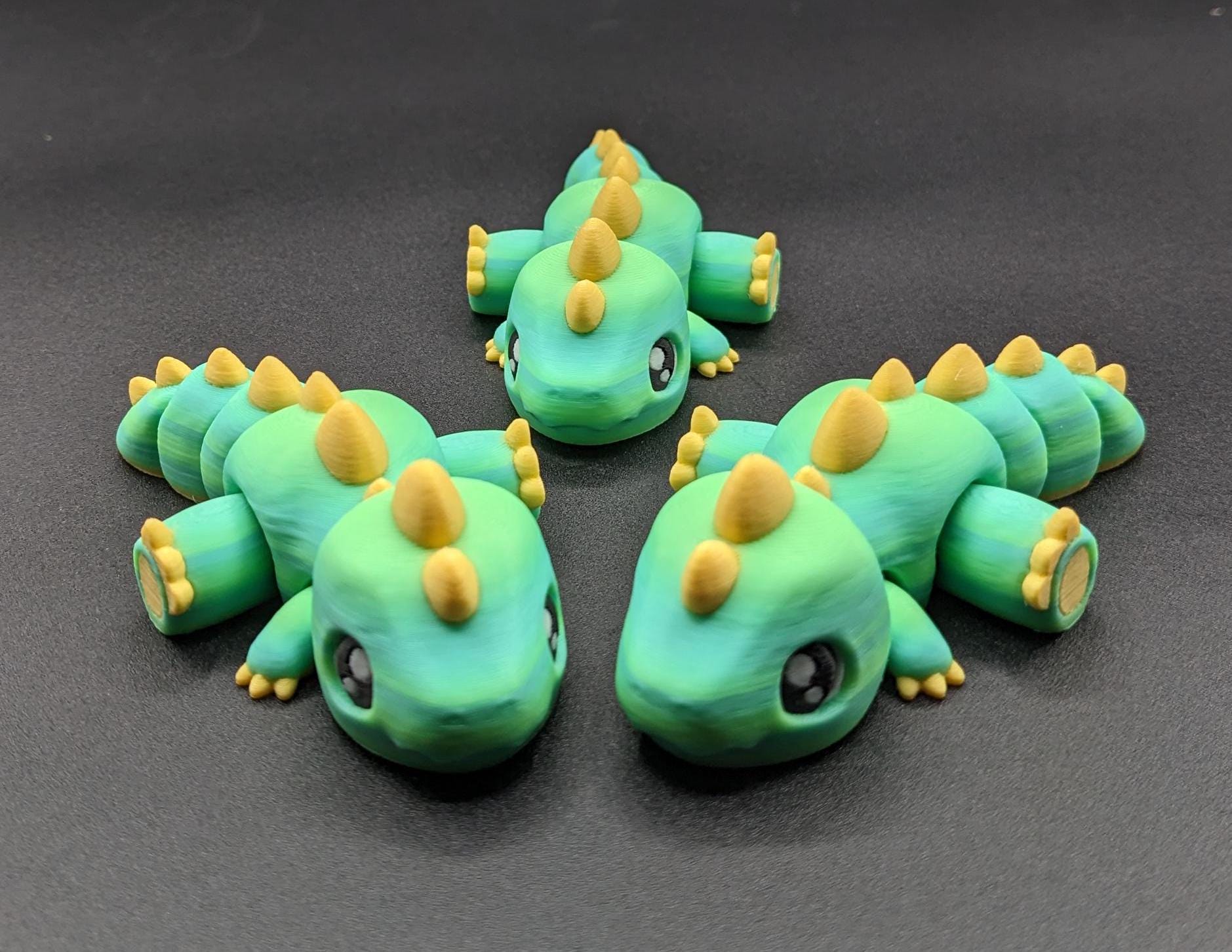 Our Adorable Articulated Baby Trex Flexi Fidget Toy is the perfect pet dinosaur! Our baby Trex  is designed to bring smiles, creativity, & stress relief to your daily routine. Perfect for fidgeting, imaginative play, or as a playful desk companion.