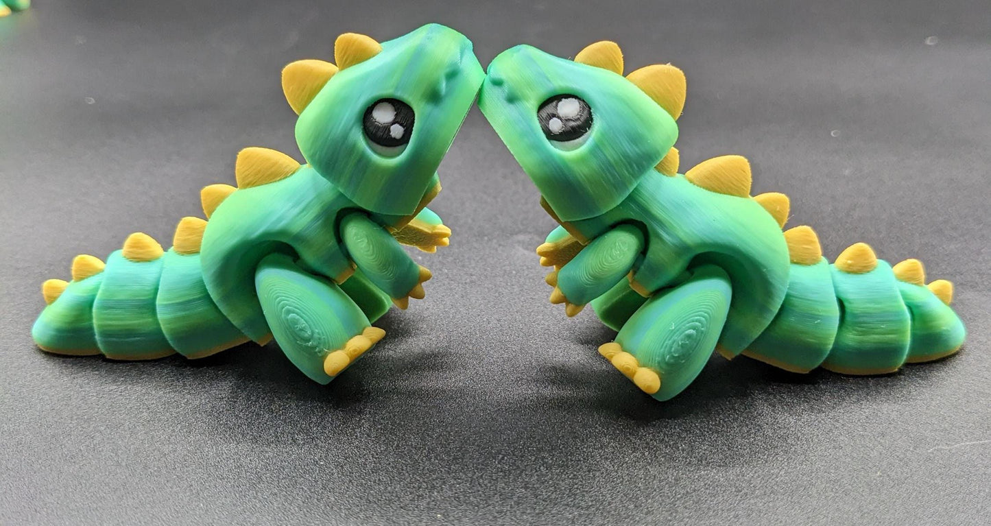 Our Adorable Articulated Baby Trex Flexi Fidget Toy is the perfect pet dinosaur! Our baby Trex  is designed to bring smiles, creativity, & stress relief to your daily routine. Perfect for fidgeting, imaginative play, or as a playful desk companion.