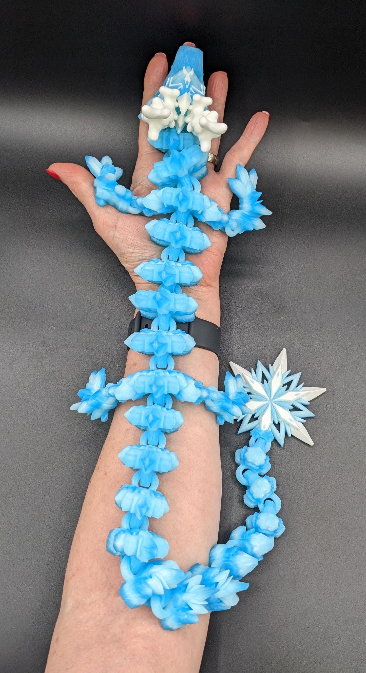 Embrace the wonder of winter with our Articulated Christmas Dragon. This stunning piece features movable joints, allowing you to pose it in various ways, enhancing its majestic presence. Color is icy translucent blue to add to the winter season.