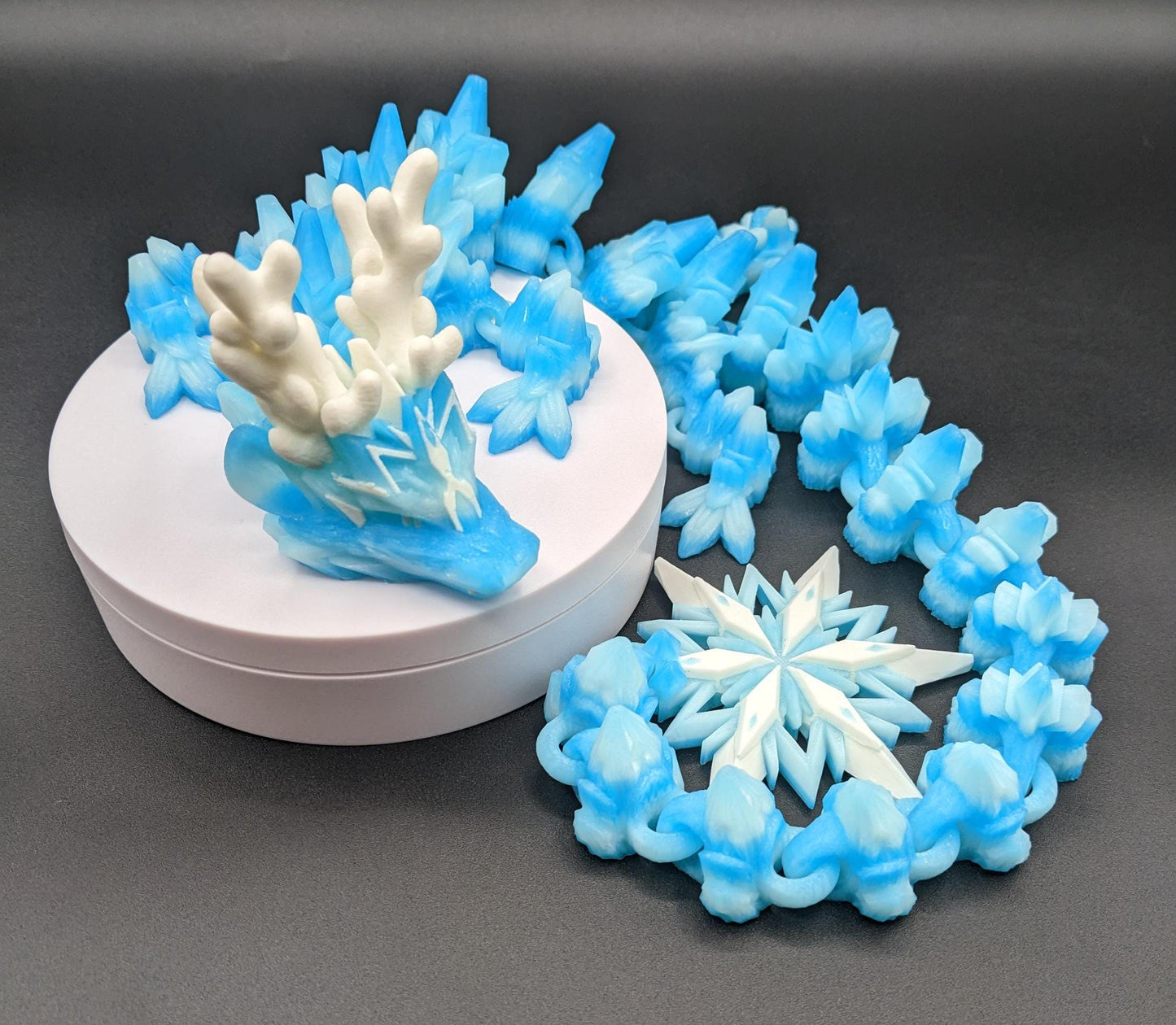 Embrace the wonder of winter with our Articulated Christmas Dragon. This stunning piece features movable joints, allowing you to pose it in various ways, enhancing its majestic presence. Color is icy translucent blue to add to the winter season.