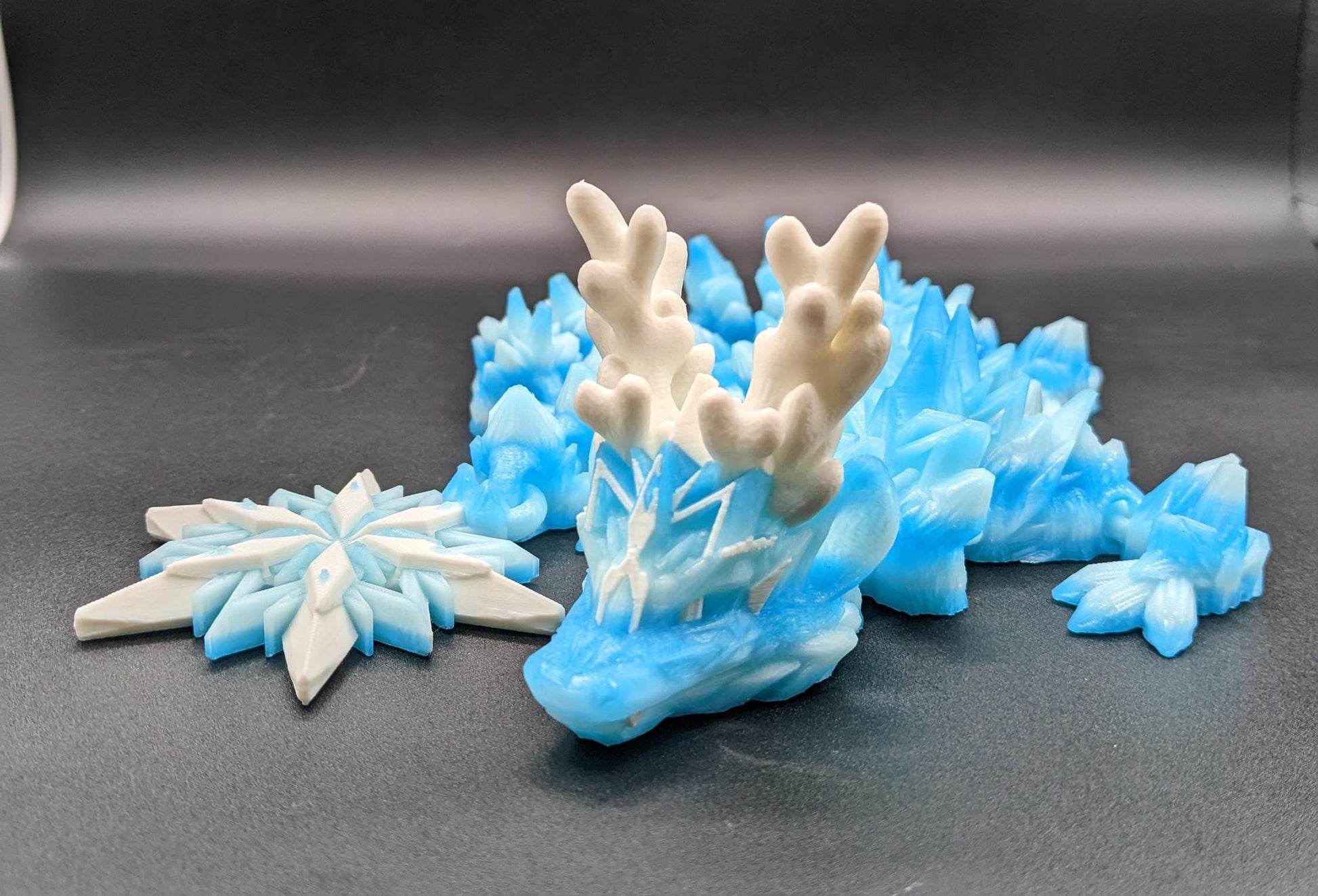 Embrace the wonder of winter with our Articulated Christmas Dragon. This stunning piece features movable joints, allowing you to pose it in various ways, enhancing its majestic presence. Color is icy translucent blue to add to the winter season.