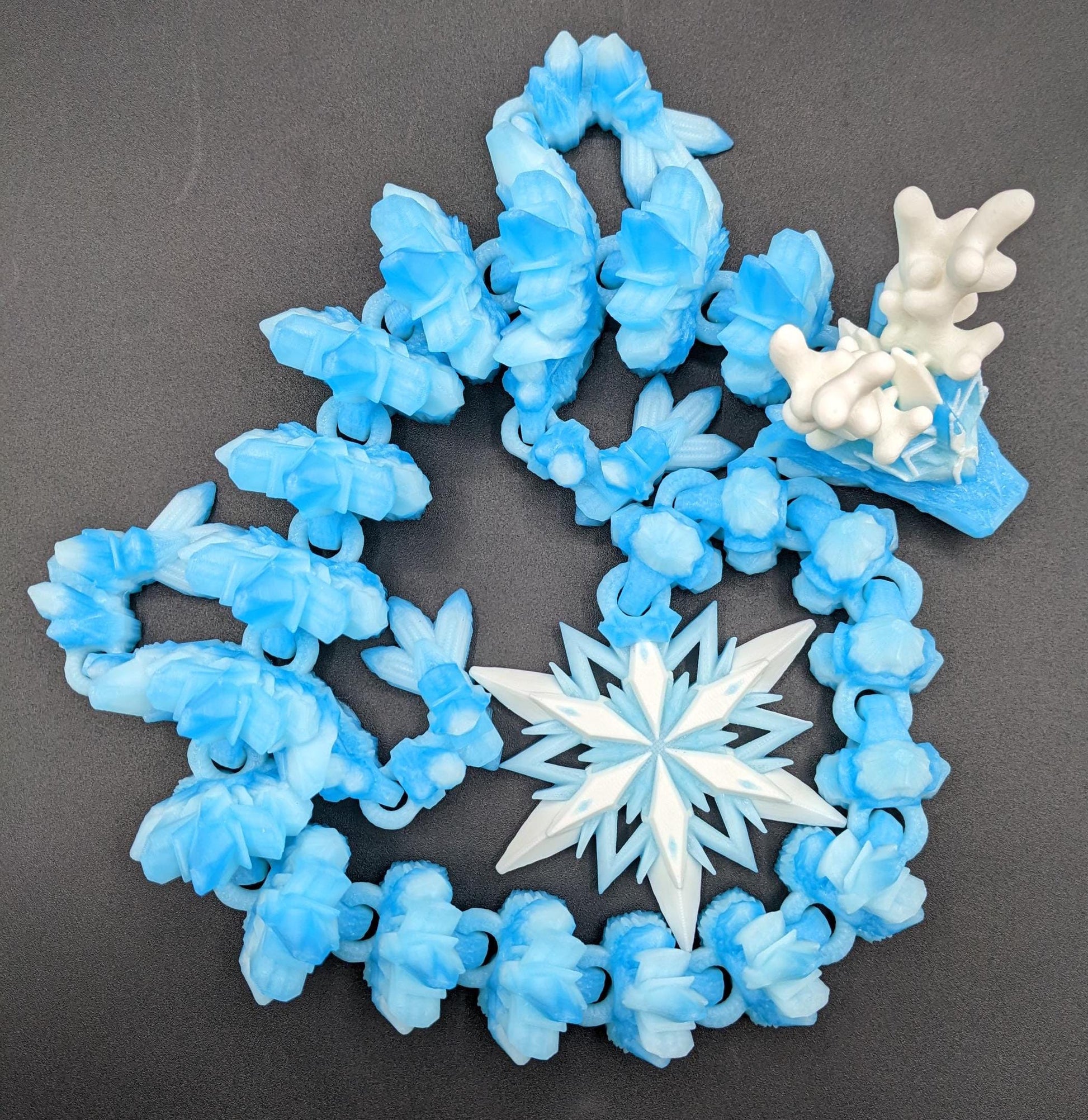 Embrace the wonder of winter with our Articulated Christmas Dragon. This stunning piece features movable joints, allowing you to pose it in various ways, enhancing its majestic presence. Color is icy translucent blue to add to the winter season.