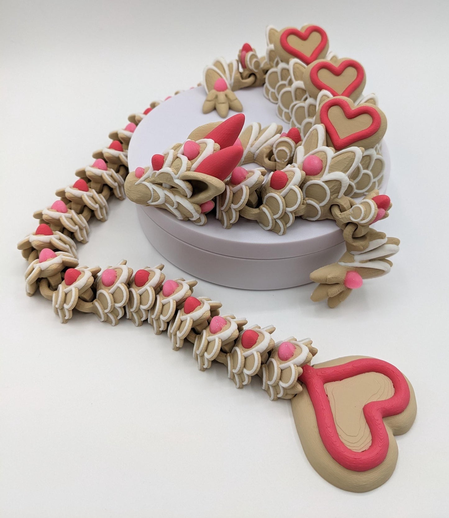 Celebrate love with the Large Articulated Valentine’s Heart Cookie Dragon Fidget Toy! This delightful 3D-printed dragon is inspired by the sweetness of cookies & the magic of Valentine’s Day, making it the perfect gift for someone you love.