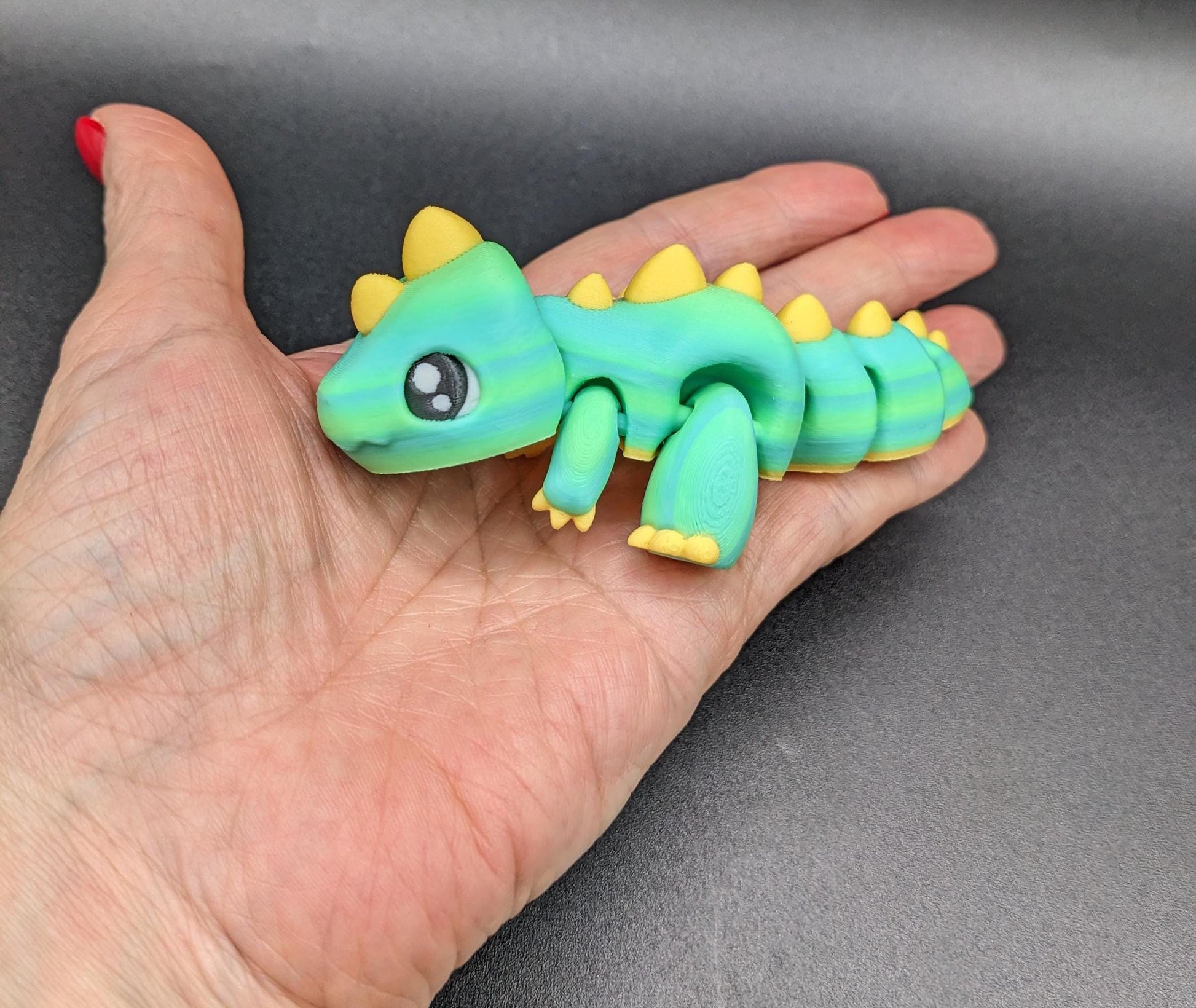 Our Adorable Articulated Baby Trex Flexi Fidget Toy is the perfect pet dinosaur! Our baby Trex  is designed to bring smiles, creativity, & stress relief to your daily routine. Perfect for fidgeting, imaginative play, or as a playful desk companion.