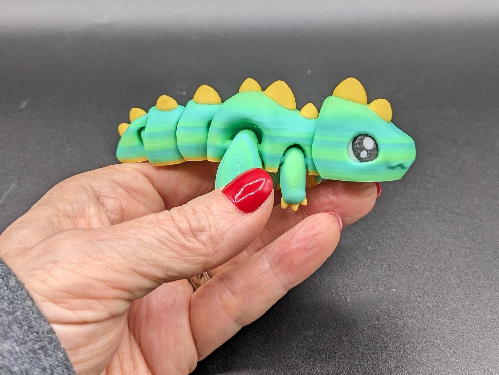 Our Adorable Articulated Baby Trex Flexi Fidget Toy is the perfect pet dinosaur! Our baby Trex  is designed to bring smiles, creativity, & stress relief to your daily routine. Perfect for fidgeting, imaginative play, or as a playful desk companion.