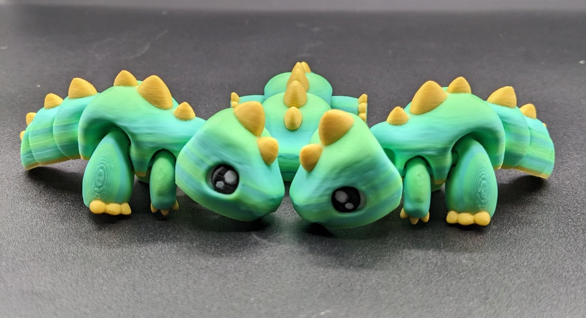 Our Adorable Articulated Baby Trex Flexi Fidget Toy is the perfect pet dinosaur! Our baby Trex  is designed to bring smiles, creativity, & stress relief to your daily routine. Perfect for fidgeting, imaginative play, or as a playful desk companion.
