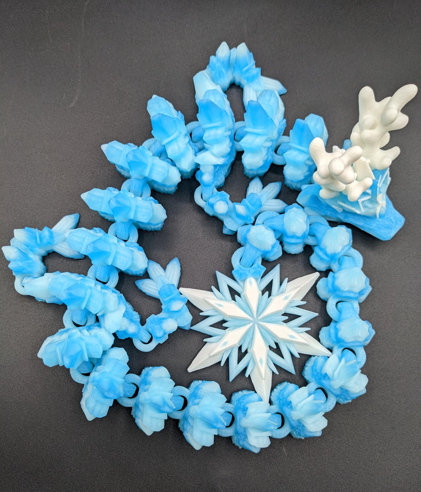 Embrace the wonder of winter with our Articulated Christmas Dragon. This stunning piece features movable joints, allowing you to pose it in various ways, enhancing its majestic presence. Color is icy translucent blue to add to the winter season.