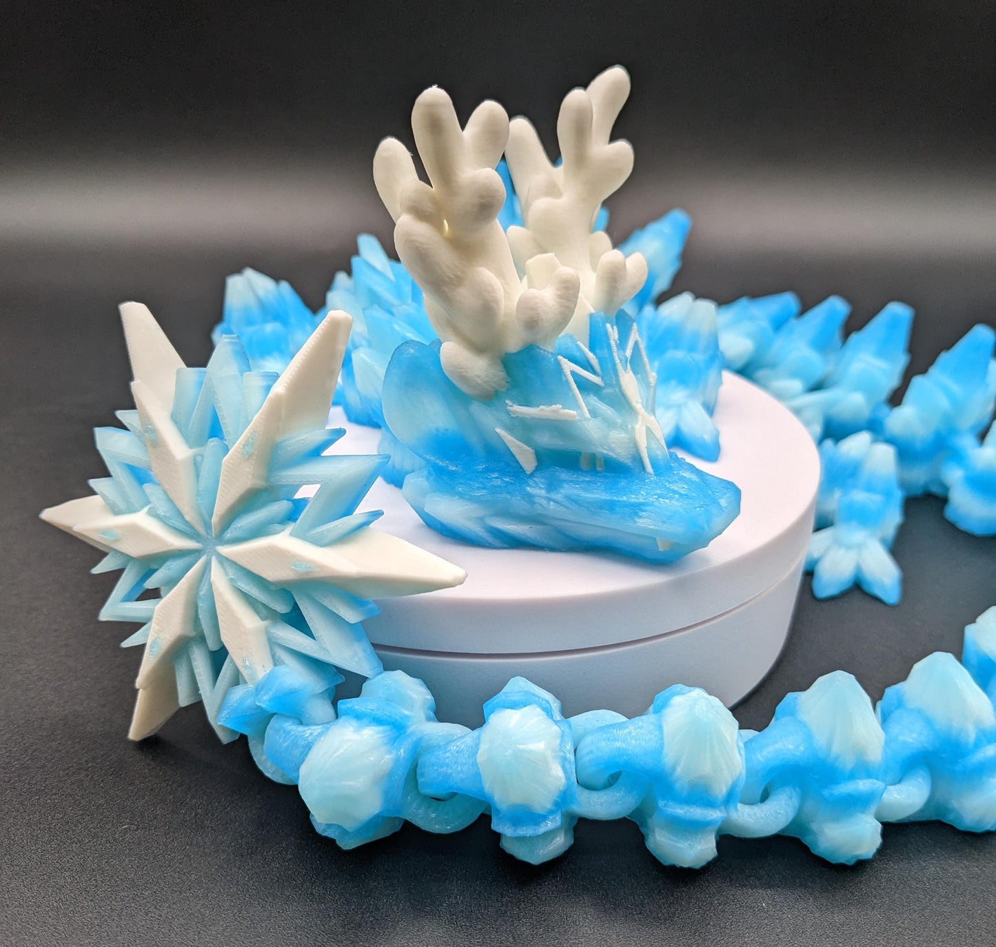 Embrace the wonder of winter with our Articulated Christmas Dragon. This stunning piece features movable joints, allowing you to pose it in various ways, enhancing its majestic presence. Color is icy translucent blue to add to the winter season.