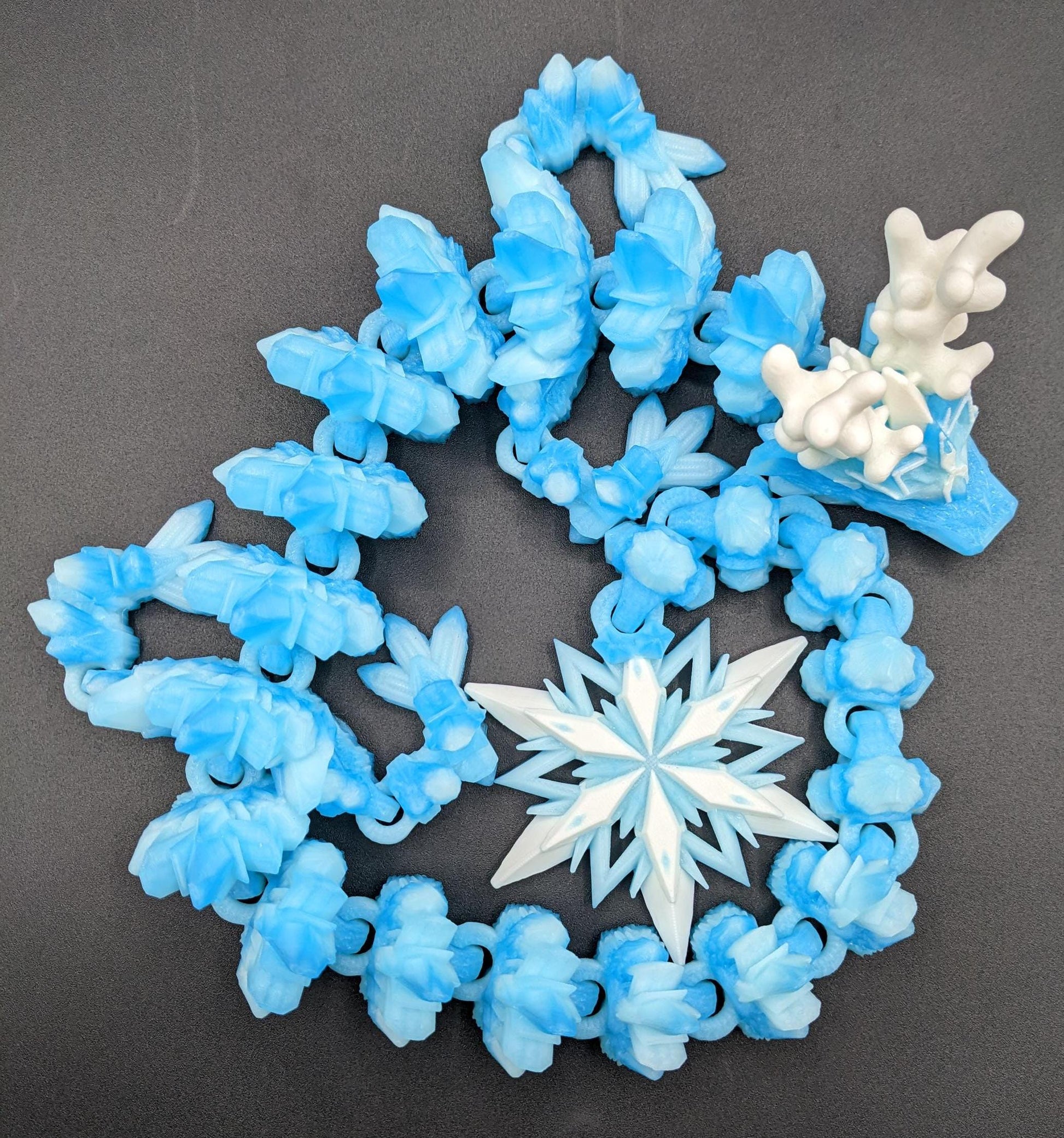 Embrace the wonder of winter with our Articulated Christmas Dragon. This stunning piece features movable joints, allowing you to pose it in various ways, enhancing its majestic presence. Color is icy translucent blue to add to the winter season.