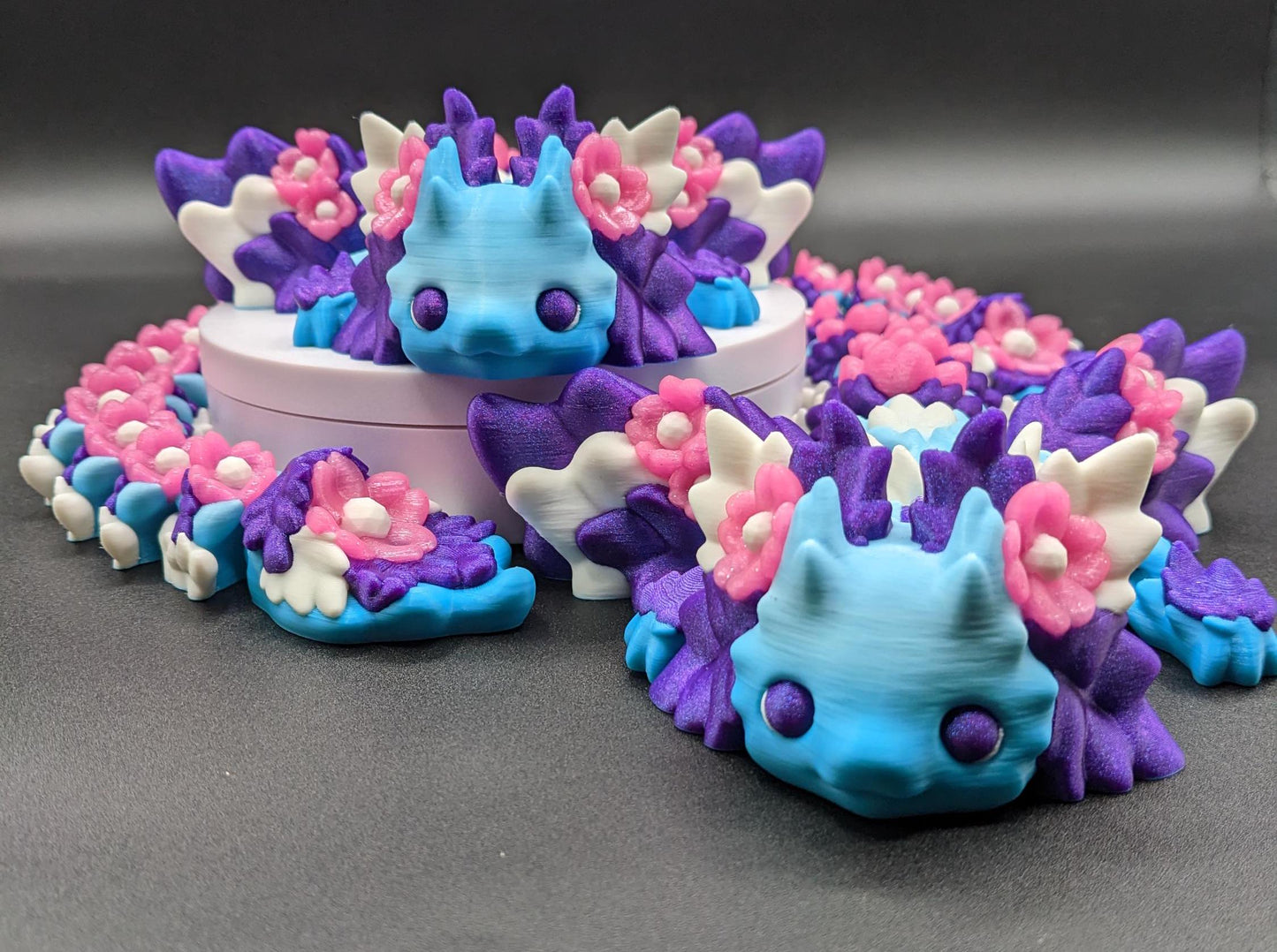 Unleash the magic of the our Beautiful Large Articulated 3D Printed Winged Kosha Axolotl Dragon! This stunning & unique creation combines the whimsical charm of an axolotl with the mythical beauty of a dragon, complete with sparkling wings & flowers.
