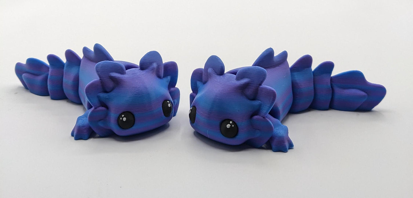 Meet the Adorable Articulated Axolotl Tadpole Fidget Toy, the perfect blend of cuteness and functionality! This 3D-printed axolotl-inspired design features fully articulated joints, making it both fun to fidget with and charming to display.