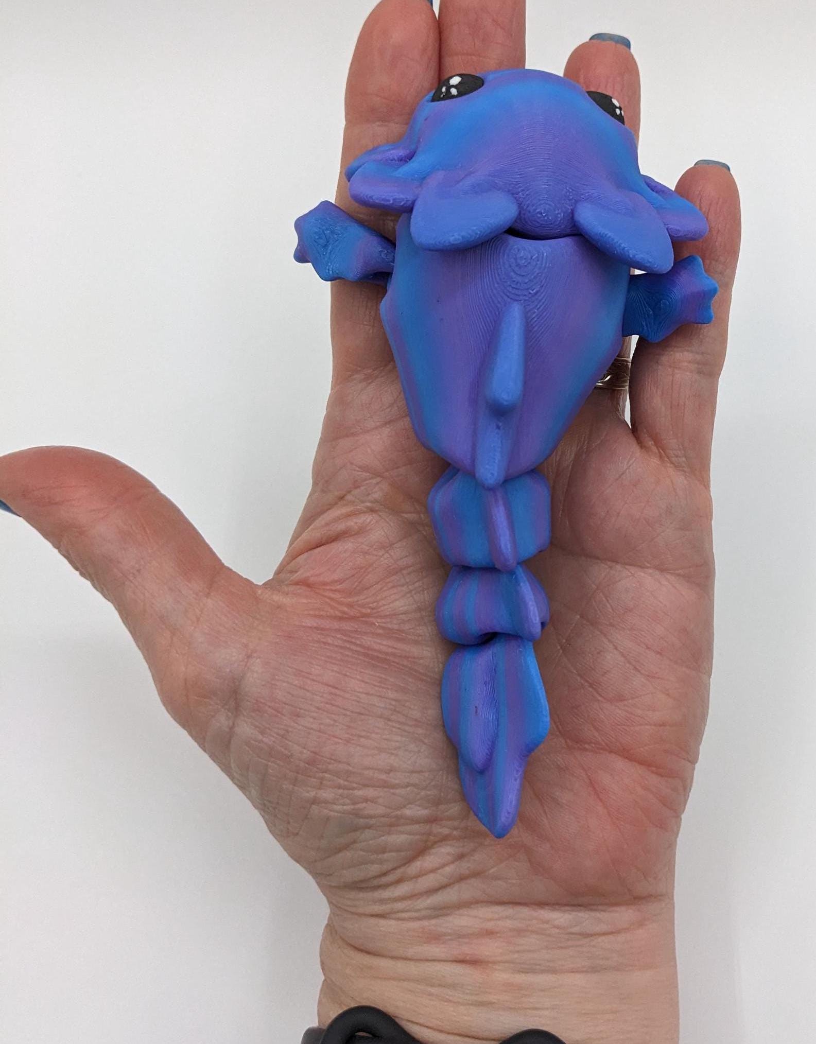 Meet the Adorable Articulated Axolotl Tadpole Fidget Toy, the perfect blend of cuteness and functionality! This 3D-printed axolotl-inspired design features fully articulated joints, making it both fun to fidget with and charming to display.