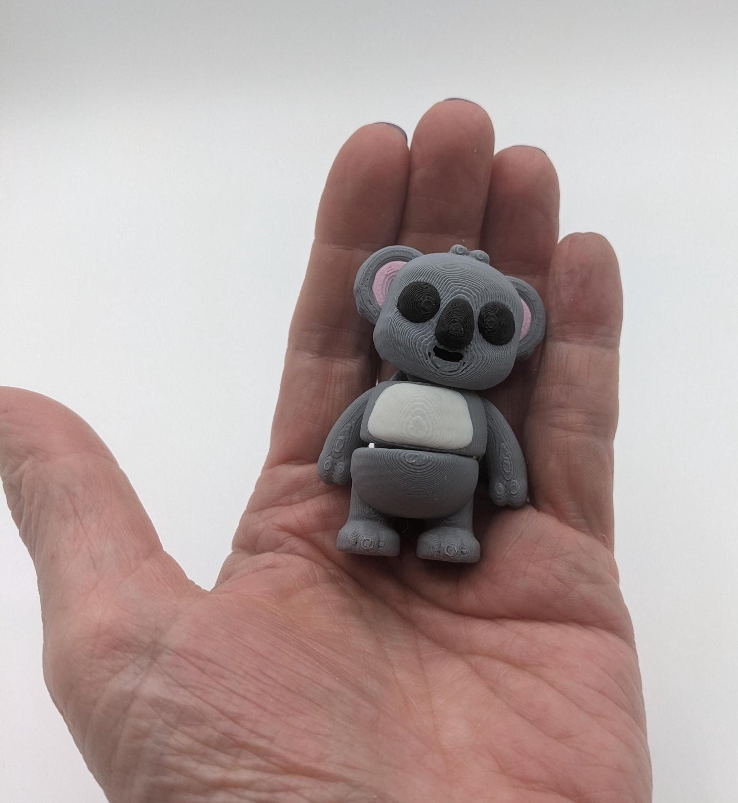 Bring cuteness and relaxation to your day with the Adorable Tiny Articulated Koala Fidget Toy! This charming 3D-printed koala is designed with  articulated joints, making it perfect for fidgeting, creative play, or as a fun pocket sized friend!