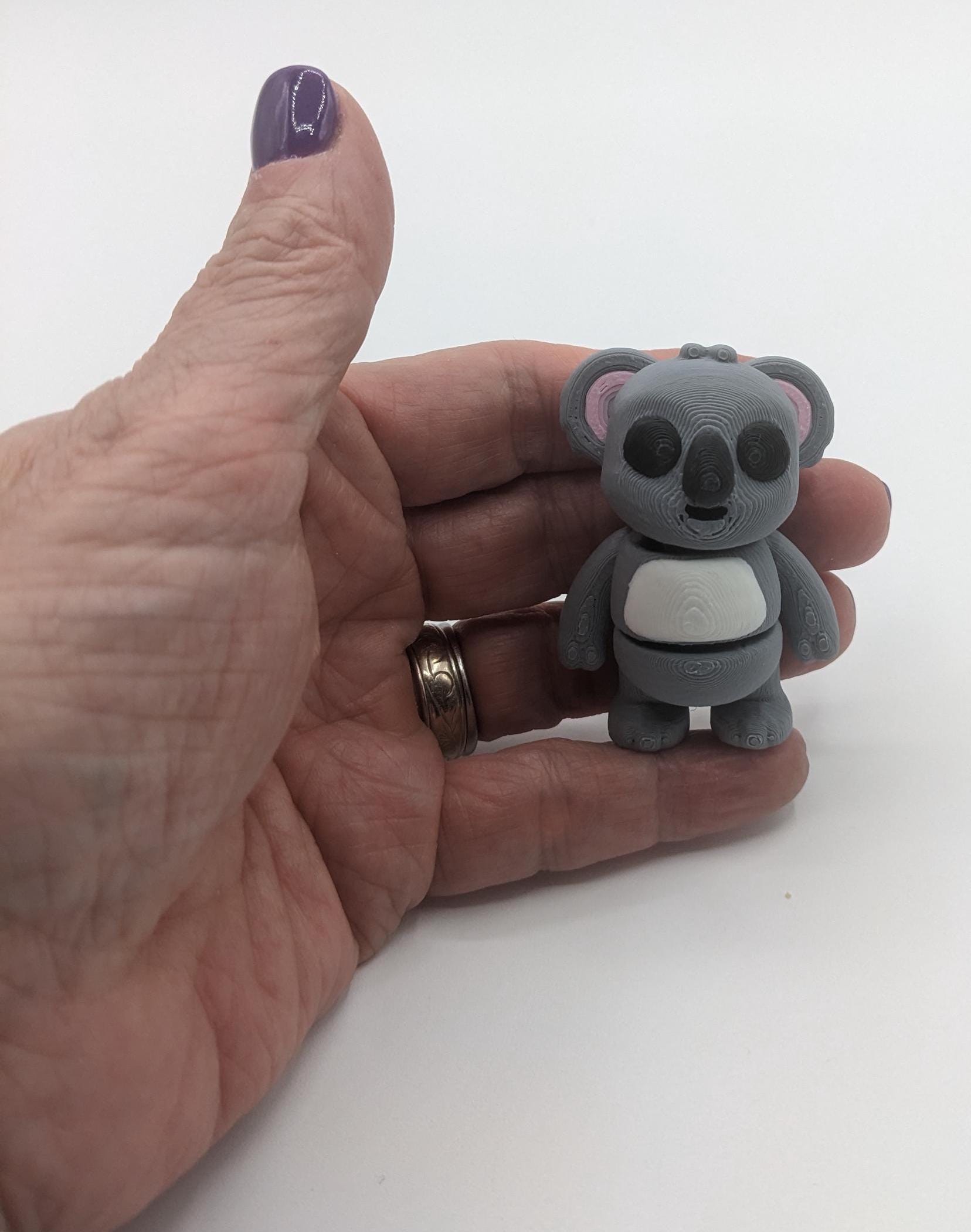 Bring cuteness and relaxation to your day with the Adorable Tiny Articulated Koala Fidget Toy! This charming 3D-printed koala is designed with  articulated joints, making it perfect for fidgeting, creative play, or as a fun pocket sized friend!